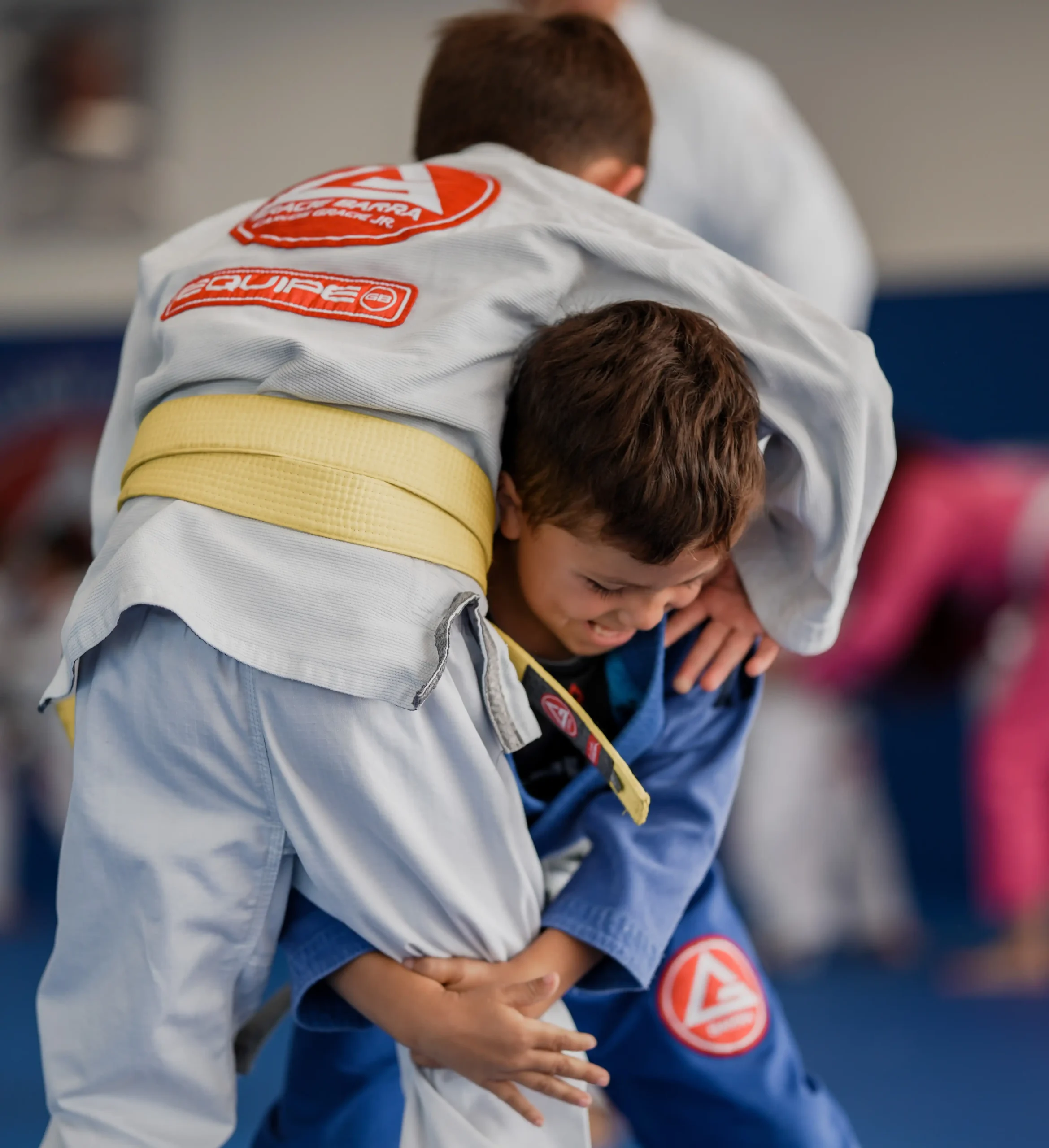 Youth Jiu-Jitsu Development Happy child learning Jiu-Jitsu discipline and focus at Gracie Barra San Marcos academy