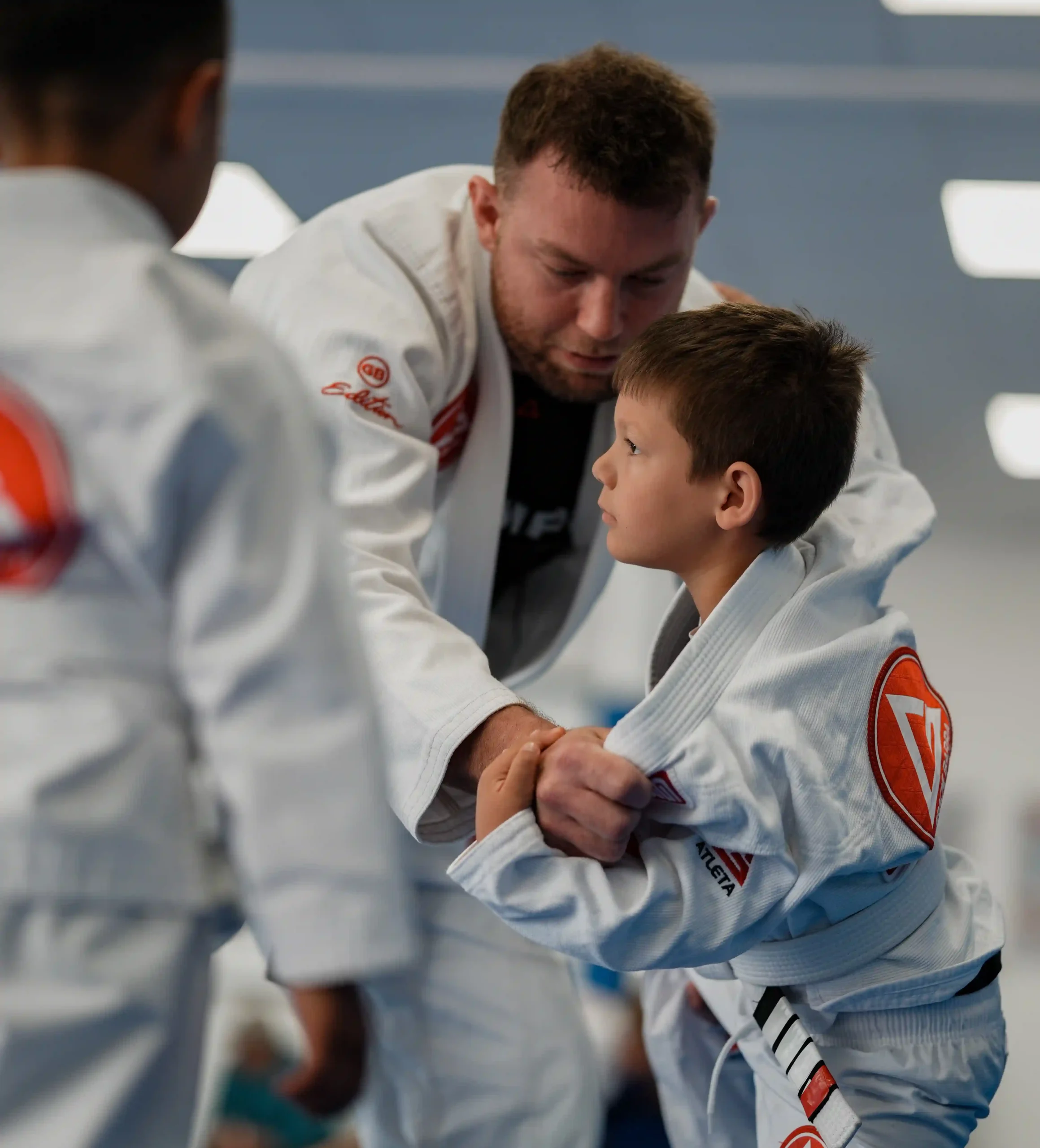 Children and teenagers practicing Brazilian Jiu-Jitsu fundamentals in San Marcos