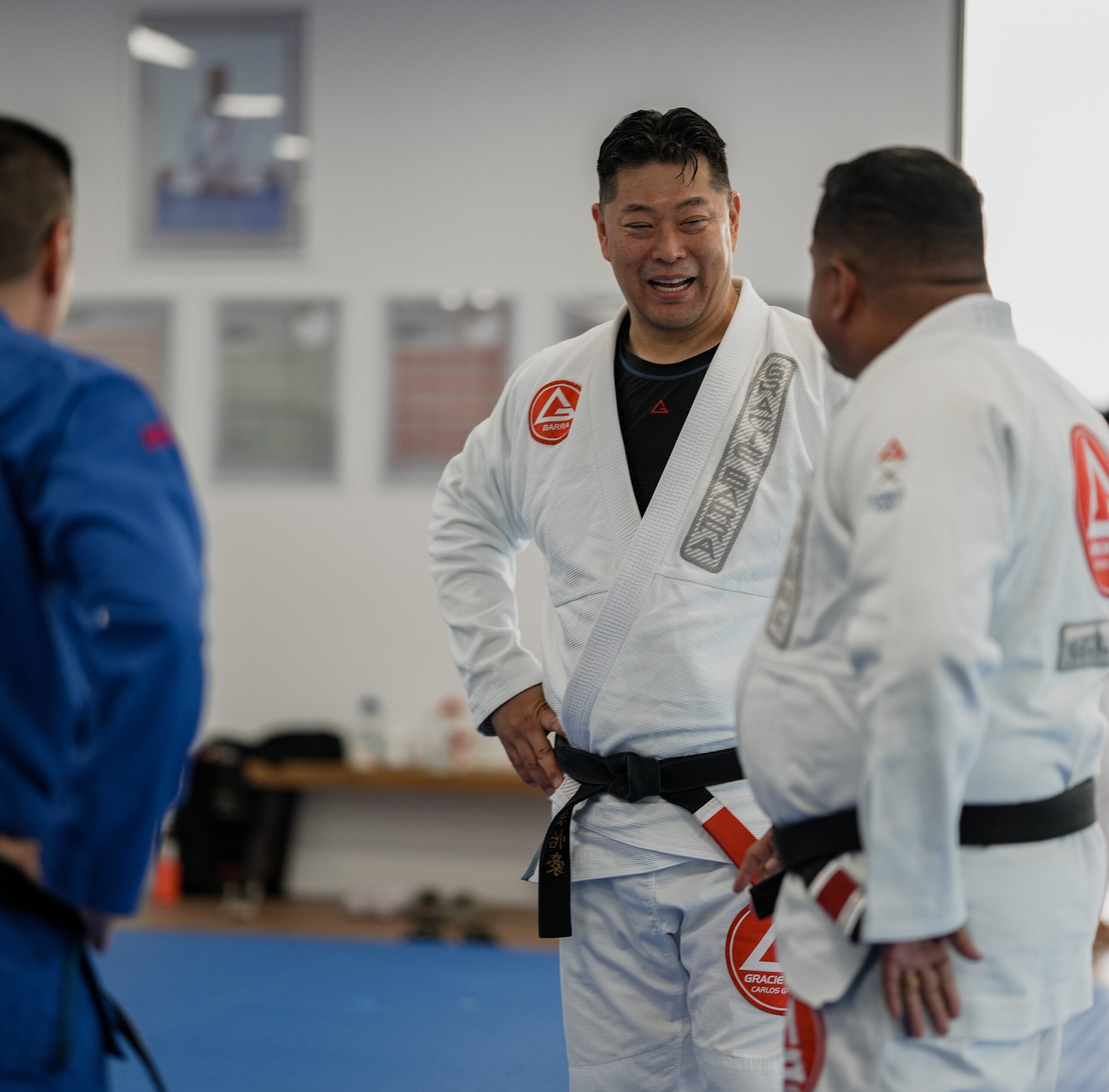 Black belt martial arts instructors demonstrating high-level BJJ techniques